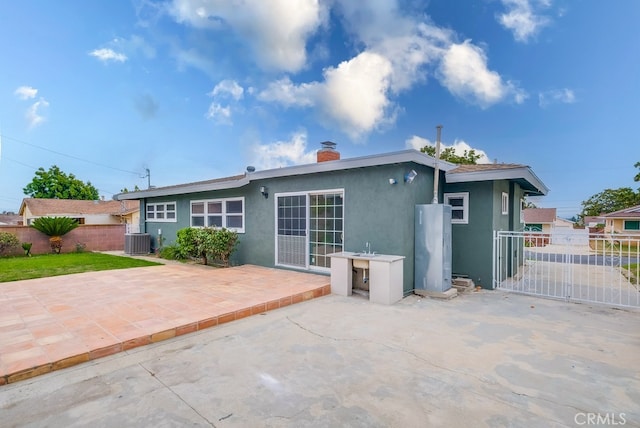 rear view of property with a patio and cooling unit