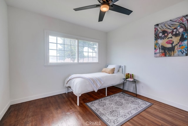 bedroom with ceiling fan and dark wood-type flooring