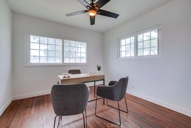 home office with dark hardwood / wood-style floors and ceiling fan