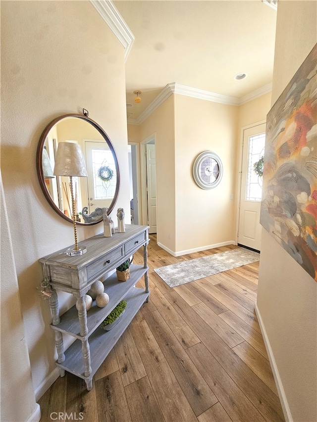 entrance foyer featuring light wood-type flooring and crown molding