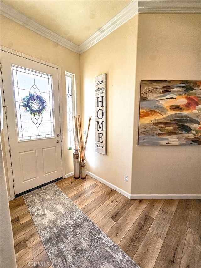 entrance foyer featuring crown molding and light hardwood / wood-style flooring