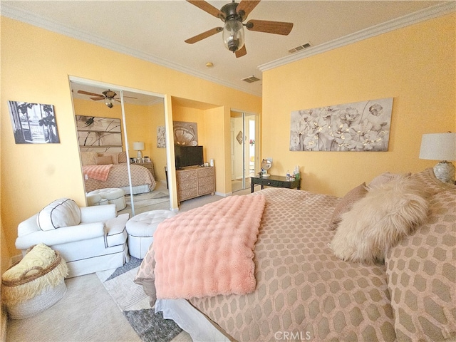 carpeted bedroom featuring a closet, crown molding, and ceiling fan