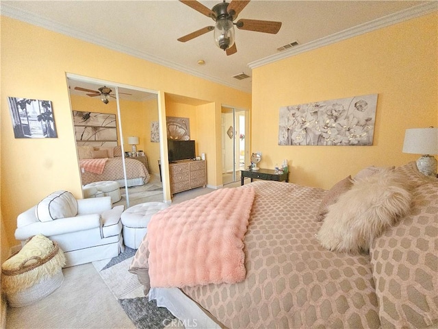 bedroom featuring multiple closets, visible vents, ornamental molding, and a ceiling fan