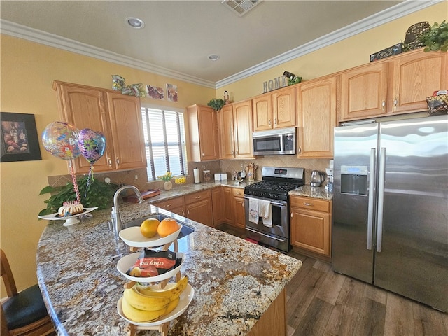 kitchen with sink, dark wood-type flooring, stainless steel appliances, light stone counters, and crown molding