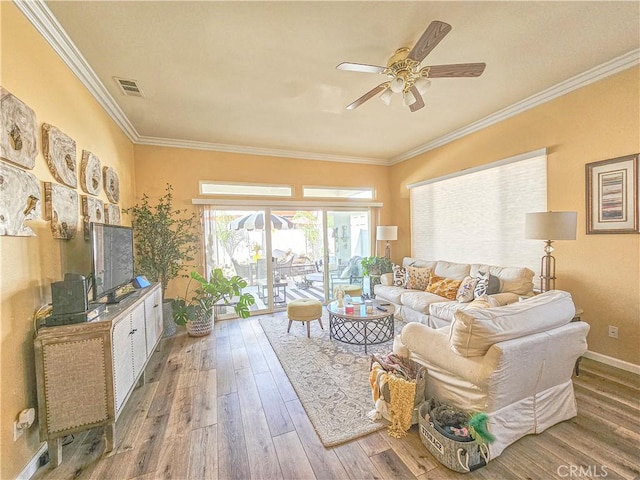 living room with hardwood / wood-style floors, ceiling fan, and ornamental molding