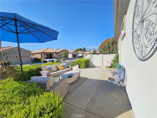 view of patio featuring outdoor lounge area, a residential view, and fence