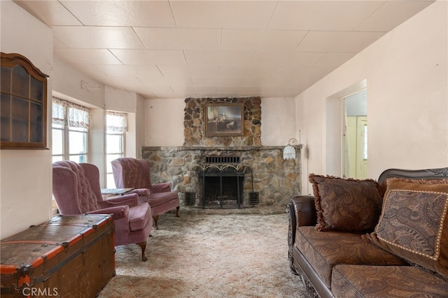 carpeted living area featuring a fireplace