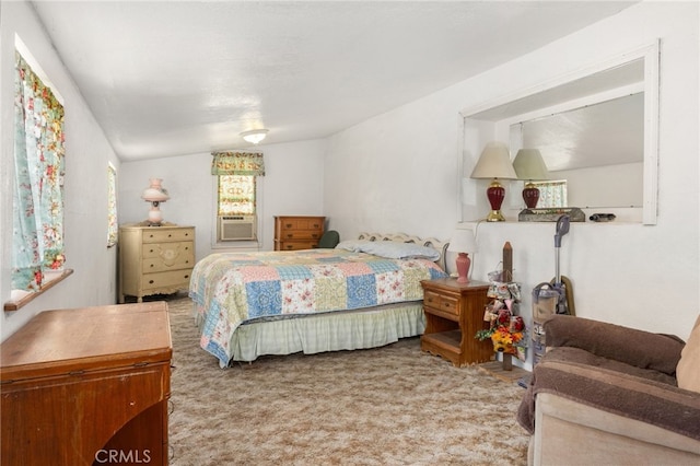 bedroom featuring cooling unit, carpet flooring, and vaulted ceiling