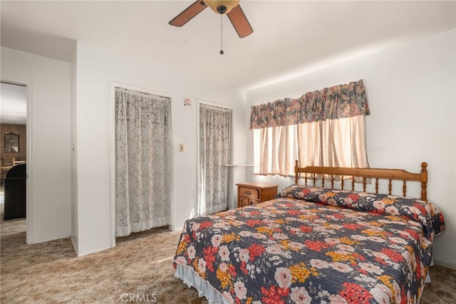 carpeted bedroom featuring ceiling fan and two closets