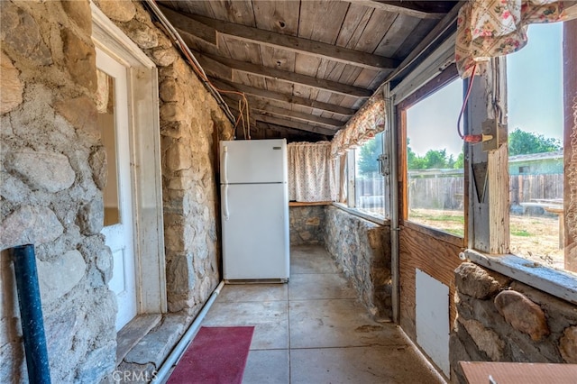 interior space featuring lofted ceiling with beams and wood ceiling