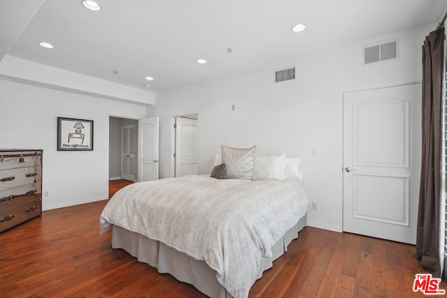 bedroom with dark wood-type flooring