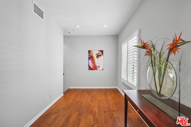 hall with wood-type flooring