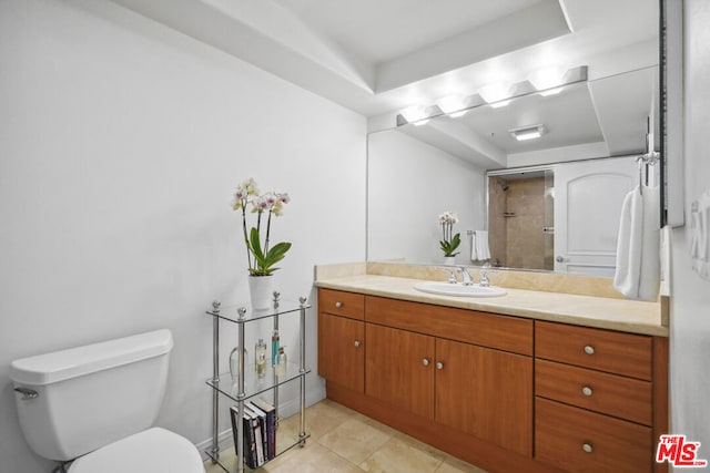 bathroom with tile patterned floors, vanity, a raised ceiling, a shower, and toilet