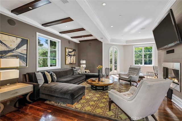 living room with crown molding, a healthy amount of sunlight, beamed ceiling, and dark hardwood / wood-style flooring