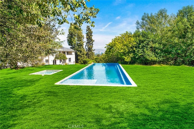 view of pool with a lawn