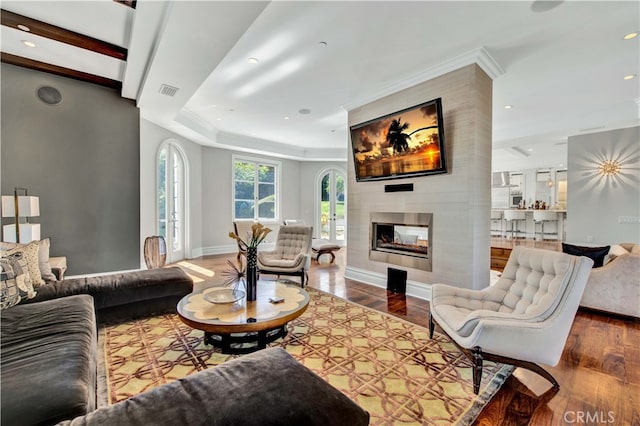 living room featuring a multi sided fireplace and hardwood / wood-style floors