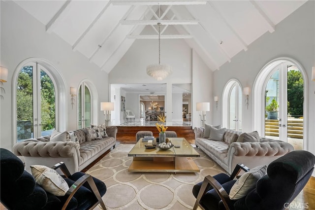 living room with a healthy amount of sunlight, light hardwood / wood-style flooring, and high vaulted ceiling