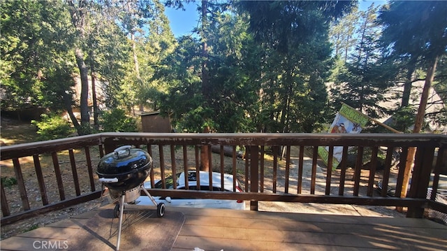 wooden terrace featuring a grill