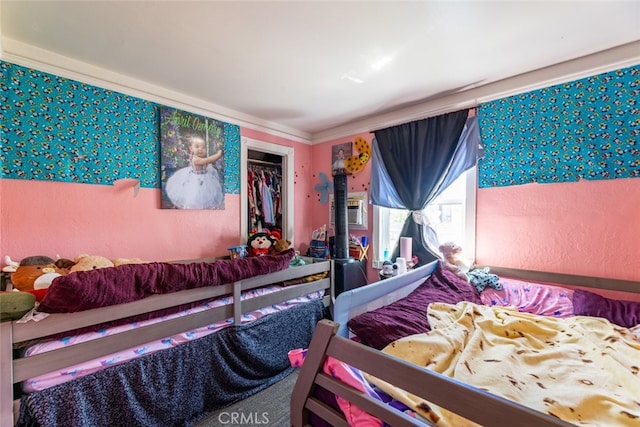 bedroom with a closet and crown molding