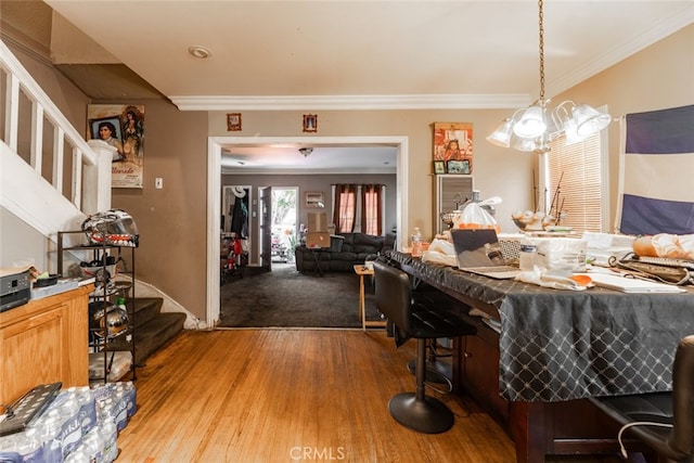 dining space featuring crown molding and hardwood / wood-style flooring