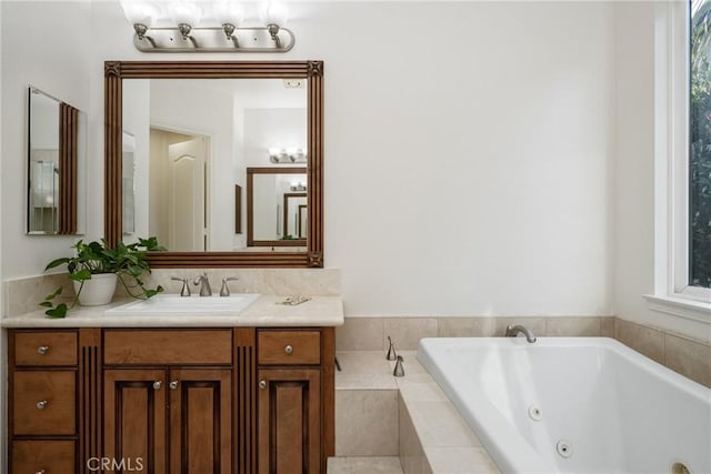 bathroom featuring a relaxing tiled tub and vanity