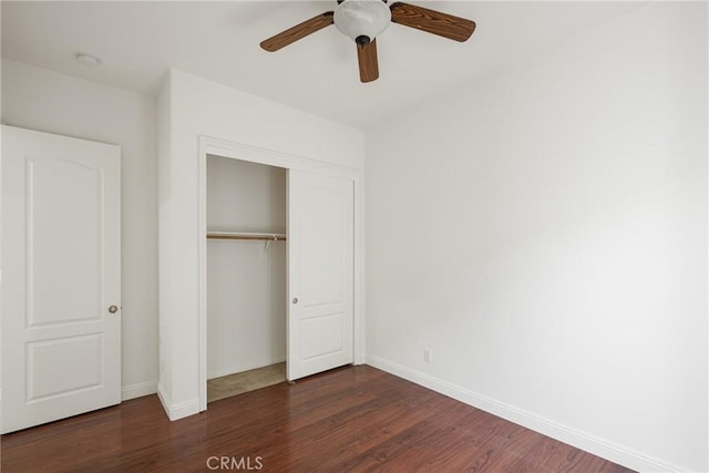 unfurnished bedroom with ceiling fan, a closet, and dark hardwood / wood-style flooring