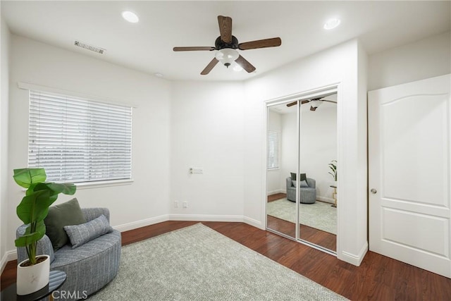 sitting room featuring ceiling fan and dark hardwood / wood-style floors