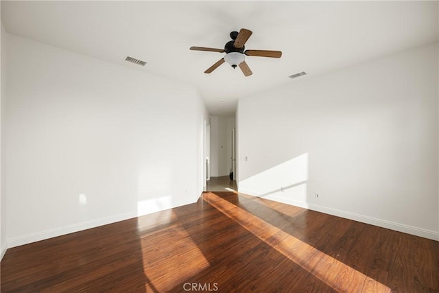 spare room with ceiling fan and dark hardwood / wood-style floors