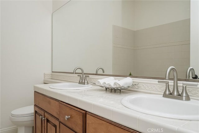 bathroom featuring toilet and vanity