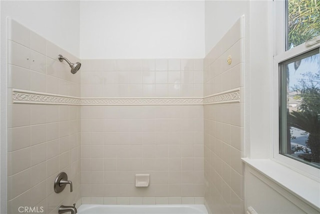 bathroom featuring tiled shower / bath