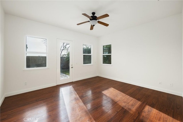 spare room with ceiling fan and dark wood-type flooring