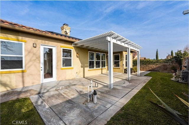 rear view of property with a patio, a lawn, and a pergola