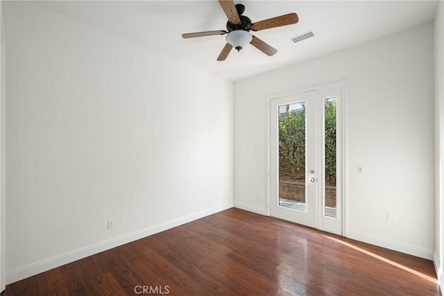 empty room with ceiling fan, french doors, and dark hardwood / wood-style floors