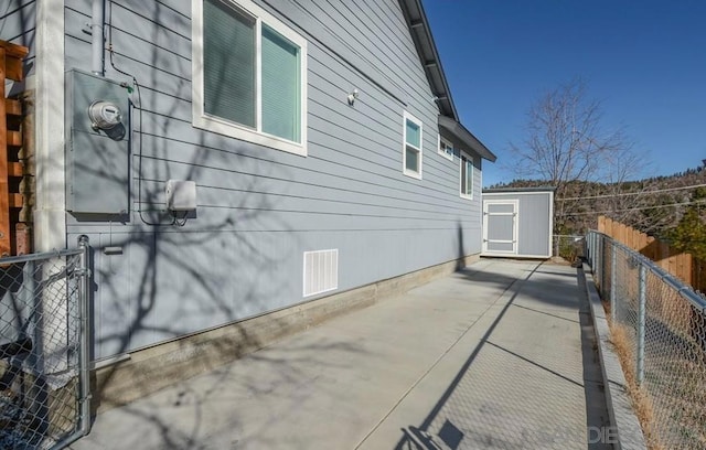 view of home's exterior with a storage unit