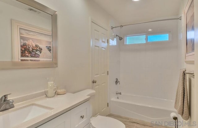 full bathroom featuring vanity, toilet, and tiled shower / bath