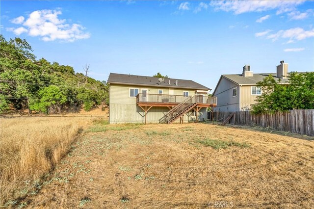 back of property with a wooden deck