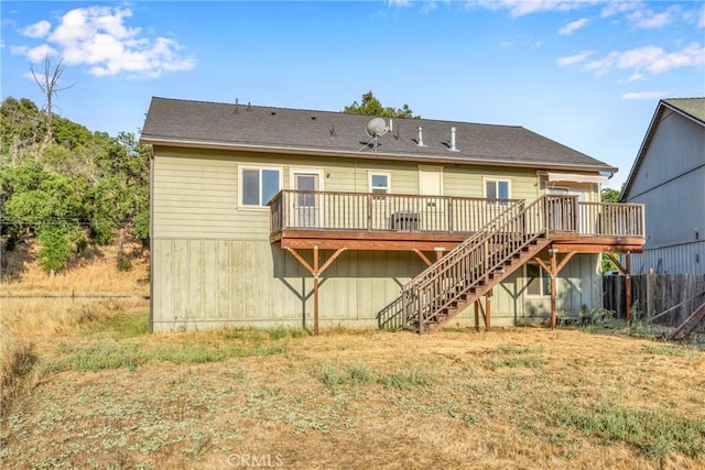 rear view of house featuring a wooden deck