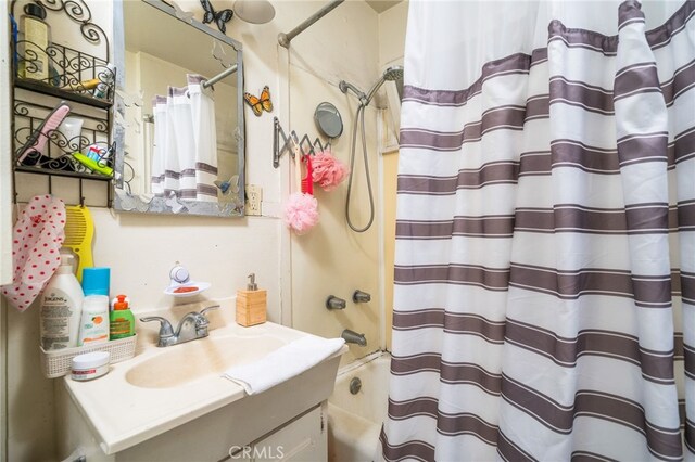 bathroom with vanity and shower / bath combo with shower curtain