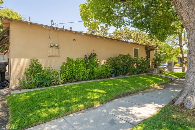 view of side of home featuring a lawn