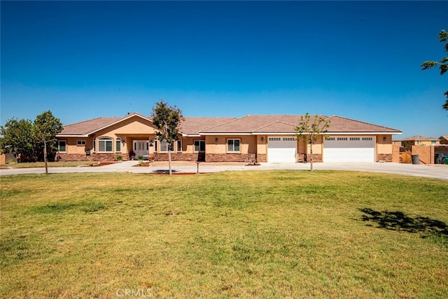 single story home with a garage and a front lawn