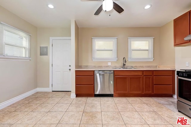 kitchen with sink, appliances with stainless steel finishes, a healthy amount of sunlight, and light tile patterned floors