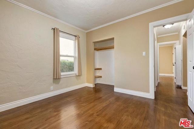 unfurnished bedroom featuring a closet, ornamental molding, and dark hardwood / wood-style floors