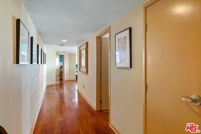 corridor featuring hardwood / wood-style floors