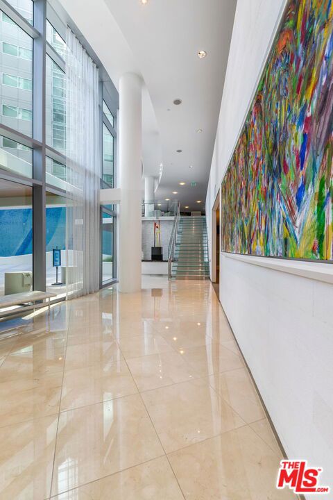 hall featuring light tile patterned floors