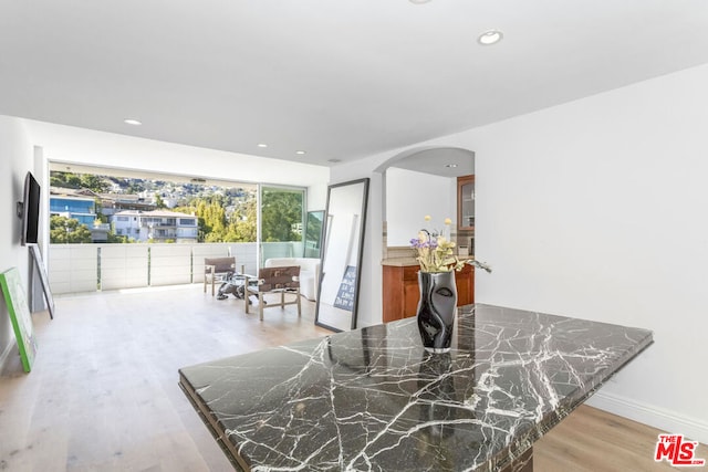 dining area with light hardwood / wood-style floors and plenty of natural light