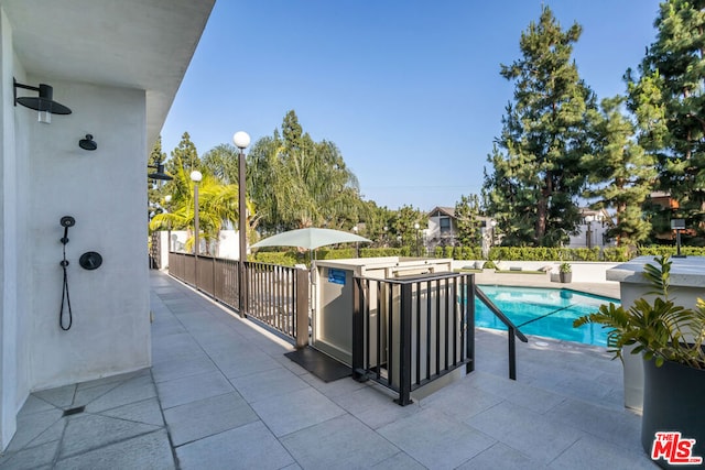 view of swimming pool featuring a patio