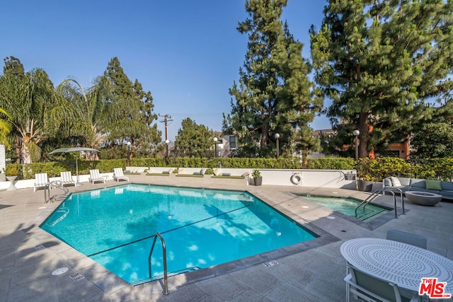 view of swimming pool featuring a patio area