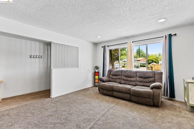 carpeted living room featuring a textured ceiling