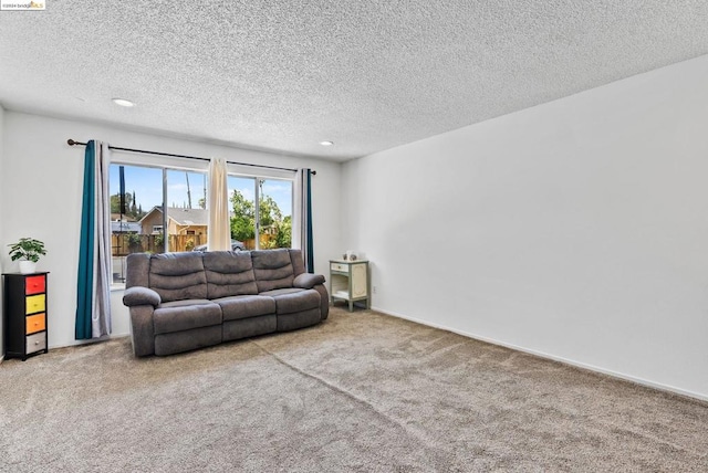 carpeted living room featuring a textured ceiling