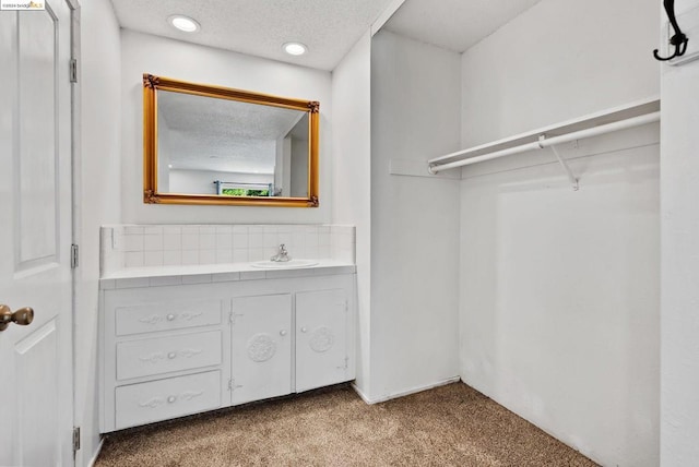 bathroom with a textured ceiling and vanity